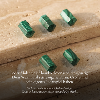 Five malachite columns with their typical banding on light stone