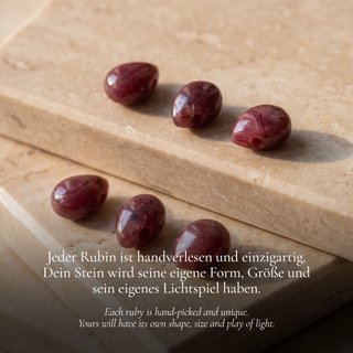 Wine red ruby teardrops along a light travertine edge