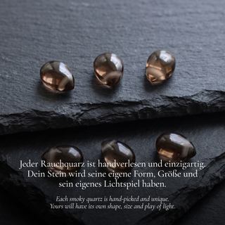 Transparent smoky quartz teardrops on black slate