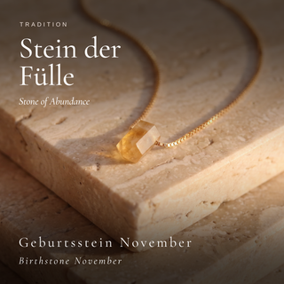 Citrine cylinder, traditionally a stone of abundance and the November birthstone, on warm stone