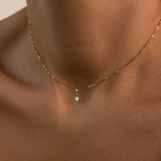 Opal Kette getragen: kleines Opalherz an goldener Kette am Dekolleté