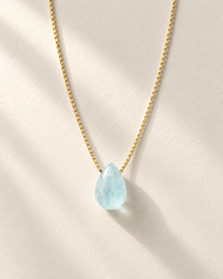 Teardrop aquamarine necklace in 14K gold-filled on cream paper